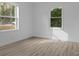 A bright bedroom with new flooring, fresh paint and large windows that fill the space with natural light at 621 E Sharpe St, Statesville, NC 28677