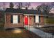 Charming brick home featuring a bright red front door, black shutters and landscaped front at 621 E Sharpe St, Statesville, NC 28677