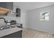 This kitchen features gray cabinetry, stainless steel appliances, and marble countertops at 621 E Sharpe St, Statesville, NC 28677