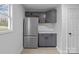 This kitchen features gray cabinetry, stainless steel appliances, and marble countertops at 621 E Sharpe St, Statesville, NC 28677