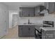 This kitchen features gray cabinetry, stainless steel appliances, and marble countertops at 621 E Sharpe St, Statesville, NC 28677