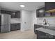 This kitchen features gray cabinetry, stainless steel appliances, and marble countertops at 621 E Sharpe St, Statesville, NC 28677