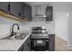 This kitchen features gray cabinetry, stainless steel appliances, and marble countertops at 621 E Sharpe St, Statesville, NC 28677