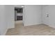 A view into the living room and kitchen, featuring vinyl plank flooring and neutral wall paint at 621 E Sharpe St, Statesville, NC 28677