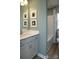 Cozy bathroom with a vanity sink, framed artwork, and a bathtub with a shower curtain at 7216 Hodges Meadow Ln, Charlotte, NC 28213