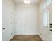 Bright foyer with wood flooring, white walls, a glass paneled front door, and two storage closets at 7216 Hodges Meadow Ln, Charlotte, NC 28213
