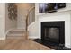 Cozy living room featuring a fireplace, staircase, wood floors, and a neutral color palette at 7216 Hodges Meadow Ln, Charlotte, NC 28213