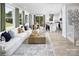 Open concept living space with a white sofa, kitchen island, dining table, and lots of natural light at 7216 Hodges Meadow Ln, Charlotte, NC 28213