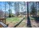 Large lush backyard, with deck, and a view of trees at 8082 Golf Course N Dr, Denver, NC 28037