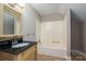 Bathroom with vanity, mirror, bathtub and tile floors at 8082 Golf Course N Dr, Denver, NC 28037