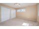 Inviting bedroom with double closets, neutral paint and carpet, and natural light at 8082 Golf Course N Dr, Denver, NC 28037