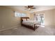 Inviting bedroom with plush carpet, a ceiling fan and a doorway leading to the outside at 8082 Golf Course N Dr, Denver, NC 28037