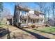 A spacious two-story home with a deck, complemented by mature trees and landscaping at 8082 Golf Course N Dr, Denver, NC 28037
