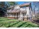 View of the home with an outdoor deck space, mature trees, and landscaped yard at 8082 Golf Course N Dr, Denver, NC 28037
