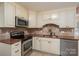 Close up shot of the kitchen with modern appliances, granite counters, and custom backsplash at 8082 Golf Course N Dr, Denver, NC 28037
