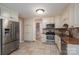 Well-lit kitchen featuring stainless steel appliances, tile floors and granite countertops at 8082 Golf Course N Dr, Denver, NC 28037