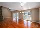 Expansive living room with wood floors, stone fireplace, and sliding glass doors to the deck at 8082 Golf Course N Dr, Denver, NC 28037