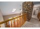 Bright open-concept living room with skylights, hardwood floors, and a stone fireplace at 8082 Golf Course N Dr, Denver, NC 28037