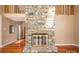 Cozy living room boasts a stone fireplace with glass doors and hardwood flooring at 8082 Golf Course N Dr, Denver, NC 28037