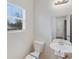Bathroom features a toilet, pedestal sink, and window at 834 N Flint St, Lincolnton, NC 28092