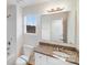 Bright bathroom featuring granite counters, a large mirror, and neutral color palette at 834 N Flint St, Lincolnton, NC 28092