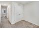 Bedroom with carpet floors, a double door closet, and access to a hallway at 834 N Flint St, Lincolnton, NC 28092