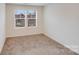 Cozy bedroom with plush carpeting and a large window providing natural light at 834 N Flint St, Lincolnton, NC 28092