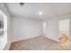 Bedroom featuring carpet floors, a window, and an open doorway to another room at 834 N Flint St, Lincolnton, NC 28092