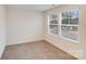 This bedroom has neutral paint, carpet, and windows to let in natural light at 834 N Flint St, Lincolnton, NC 28092