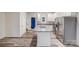 Open kitchen with granite countertops, stainless appliances, and an island sink at 834 N Flint St, Lincolnton, NC 28092