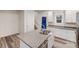Kitchen island features granite countertops, a stainless steel sink, and white cabinets at 834 N Flint St, Lincolnton, NC 28092