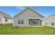 View of the home's backyard, vinyl siding, windows, back patio, and lawn at 8421 Norman Forest Rd, Lancaster, SC 29720