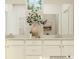 Elegant bathroom with double vanity, quartz countertop, decorative vase, and a large framed mirror at 8421 Norman Forest Rd, Lancaster, SC 29720