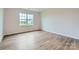 Well-lit bedroom featuring a large window and hardwood floors at 8421 Norman Forest Rd, Lancaster, SC 29720