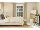 Bright bedroom featuring a plush bed, stylish curtains, a bench, and decorative artwork at 8421 Norman Forest Rd, Lancaster, SC 29720