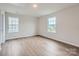 Bright bedroom featuring two windows and hardwood floors at 8421 Norman Forest Rd, Lancaster, SC 29720