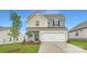 Charming two-story home with a well-manicured lawn and attached two-car garage at 8421 Norman Forest Rd, Lancaster, SC 29720
