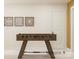 Entertainment space features a classic foosball table with modern art hanging above at 8421 Norman Forest Rd, Lancaster, SC 29720