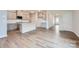Modern kitchen featuring white cabinets, a kitchen island, stainless steel appliances and hardwood floors at 8421 Norman Forest Rd, Lancaster, SC 29720