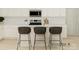 Modern kitchen with white cabinets, sleek countertops, stainless steel appliances, and breakfast bar seating at 8421 Norman Forest Rd, Lancaster, SC 29720