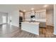 Modern kitchen featuring white cabinets, a kitchen island, stainless steel appliances and hardwood floors at 8421 Norman Forest Rd, Lancaster, SC 29720