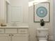 Clean bathroom featuring a vanity with modern fixtures, a toilet, and minimalist decor at 8426 Norman Forest Rd, Lancaster, SC 29720