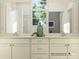 Bright bathroom with double sink vanity, white cabinetry, and a large window offering natural light at 8426 Norman Forest Rd, Lancaster, SC 29720