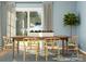 Elegant dining room with a wooden table, modern chairs, patterned rug, and large windows at 8426 Norman Forest Rd, Lancaster, SC 29720