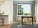 Bright dining room with a wooden table, stylish chairs, a patterned rug, and large windows at 8426 Norman Forest Rd, Lancaster, SC 29720