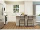 Bright, modern kitchen featuring white cabinets, stainless steel appliances, a center island, and hardwood floors at 8426 Norman Forest Rd, Lancaster, SC 29720