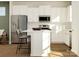 Modern kitchen features stainless steel appliances, white cabinetry, and a large center island with bar stool seating at 8426 Norman Forest Rd, Lancaster, SC 29720