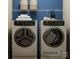 Modern laundry room featuring front load washer/dryer, shelving, and contemporary design elements at 8426 Norman Forest Rd, Lancaster, SC 29720