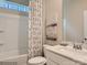 Bright bathroom with a white vanity, framed mirror, and a shower-tub combination with a patterned curtain at 8436 Norman Forest Rd, Lancaster, SC 29720