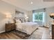 Inviting main bedroom with a large window, plush bedding, and stylish decor, creating a relaxing and private retreat at 8436 Norman Forest Rd, Lancaster, SC 29720
